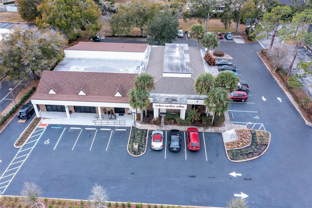 An aerial view shows a commercial building with a parking lot and surrounding landscaping — 945 STATE ROAD 436 UNIT B and C, CASSELBERRY, FL