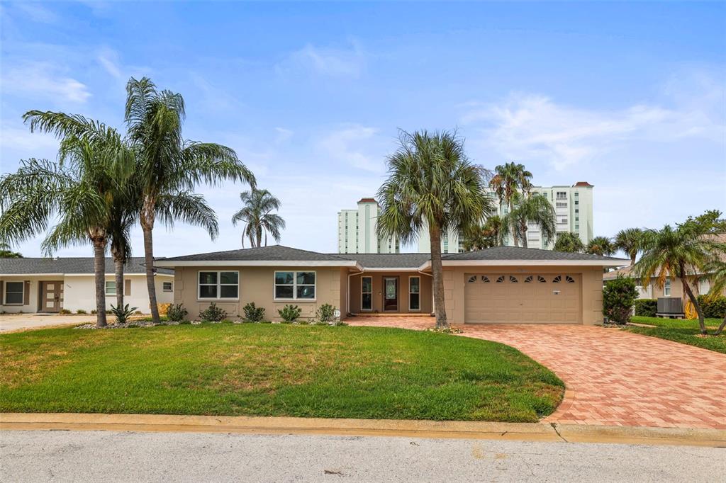 A single-story house with a tan exterior, a paved driveway, and several palm trees — 6360 2ND PALM POINT, ST PETERSBURG, FL