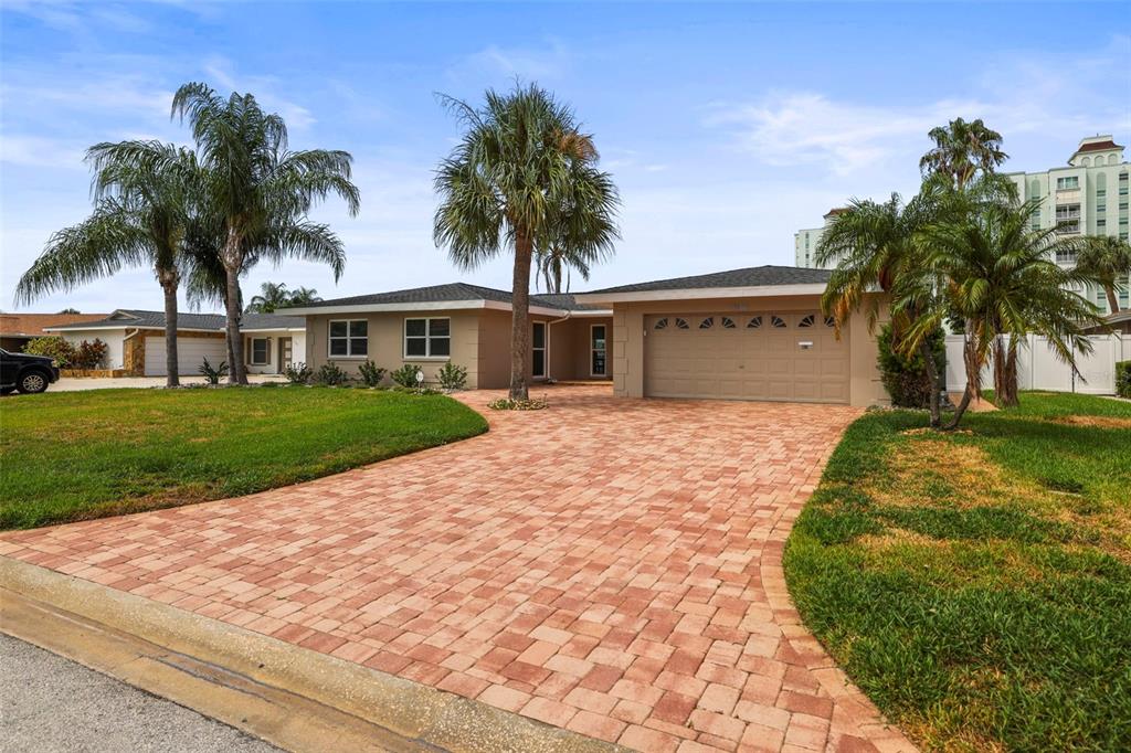 A single-story house with a paved driveway, palm trees, and a two-car garage — 6360 2ND PALM POINT, ST PETERSBURG, FL