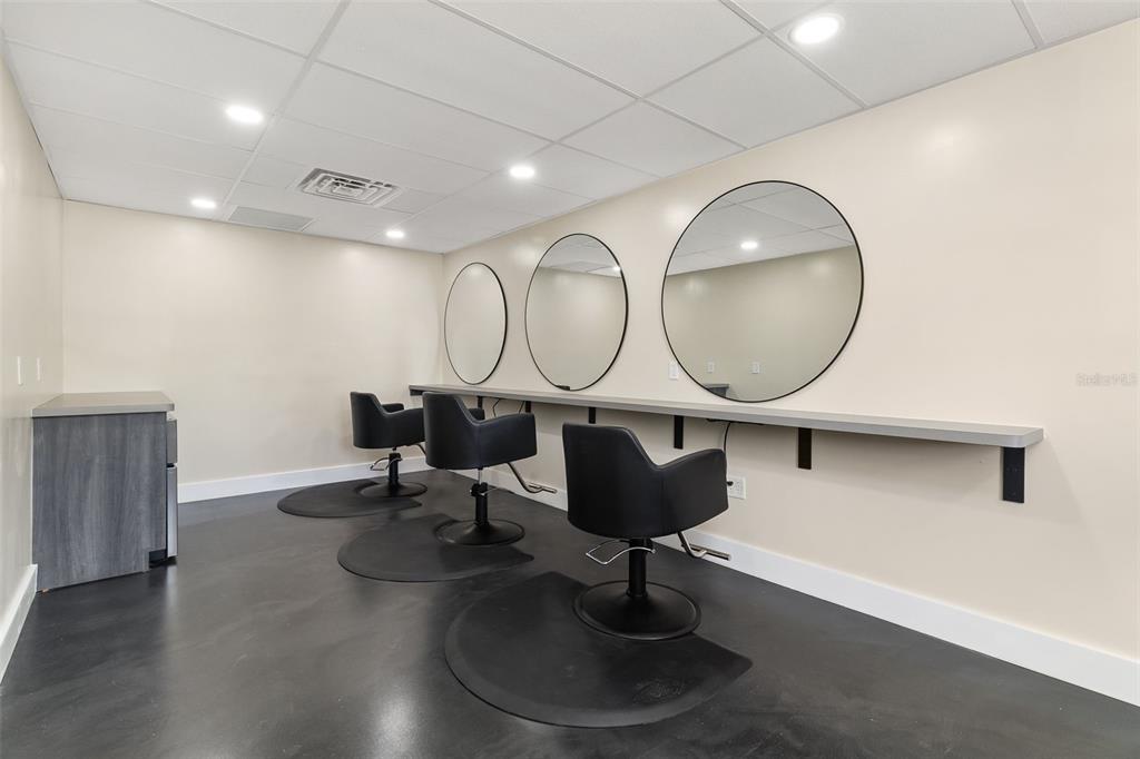A salon room features three black chairs, circular mirrors, and a long counter against a wall — 1900 TAMIAMI TRAIL UNIT C & D, PUNTA GORDA, FL