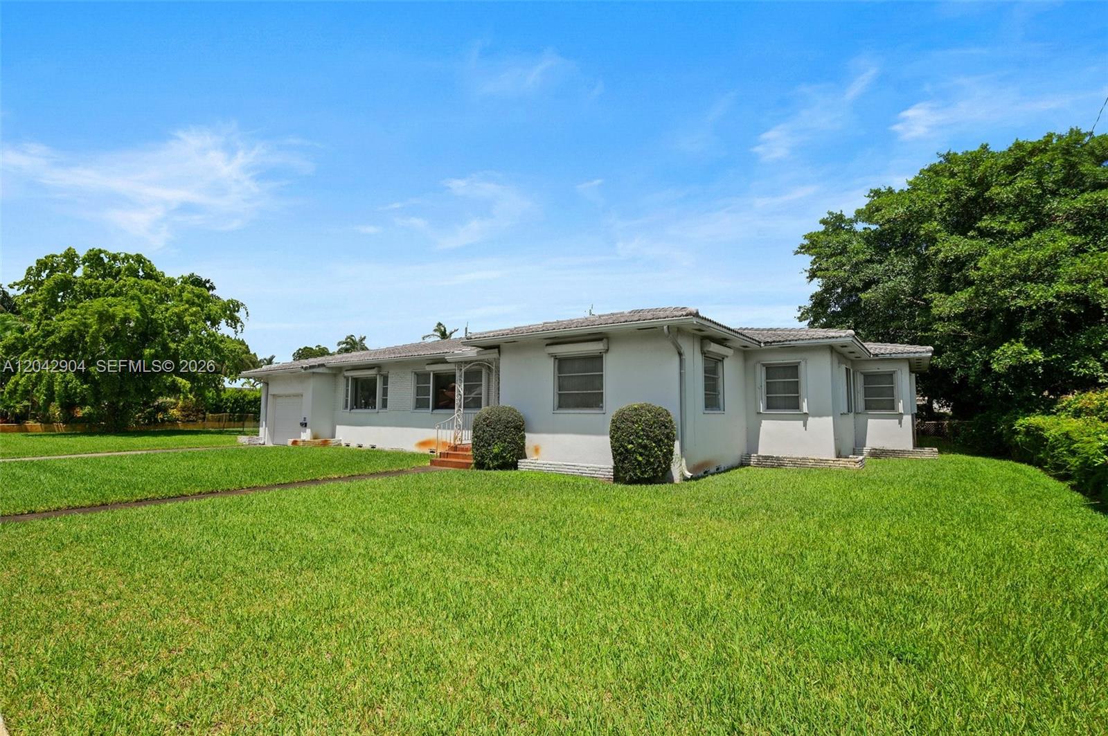 A single-story house with a light-colored exterior, a tiled roof, and a large front lawn — 20 SW 4th St, Dania Beach FL 33004, DANIA BEACH, FL
