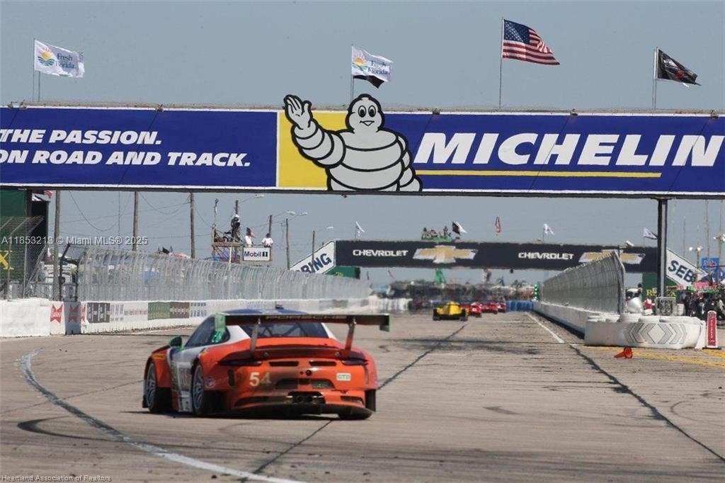 A race car drives under a large Michelin banner at a professional racetrack — 2124 Abington, Sebring FL 33875, SEBRING, FL
