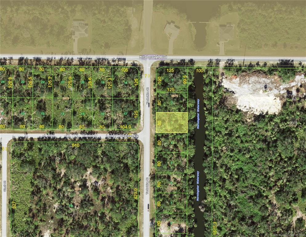 This is a map showing a highlighted residential lot located along a street and waterway — 26 YORKSHIRE STREET, PORT CHARLOTTE, FL