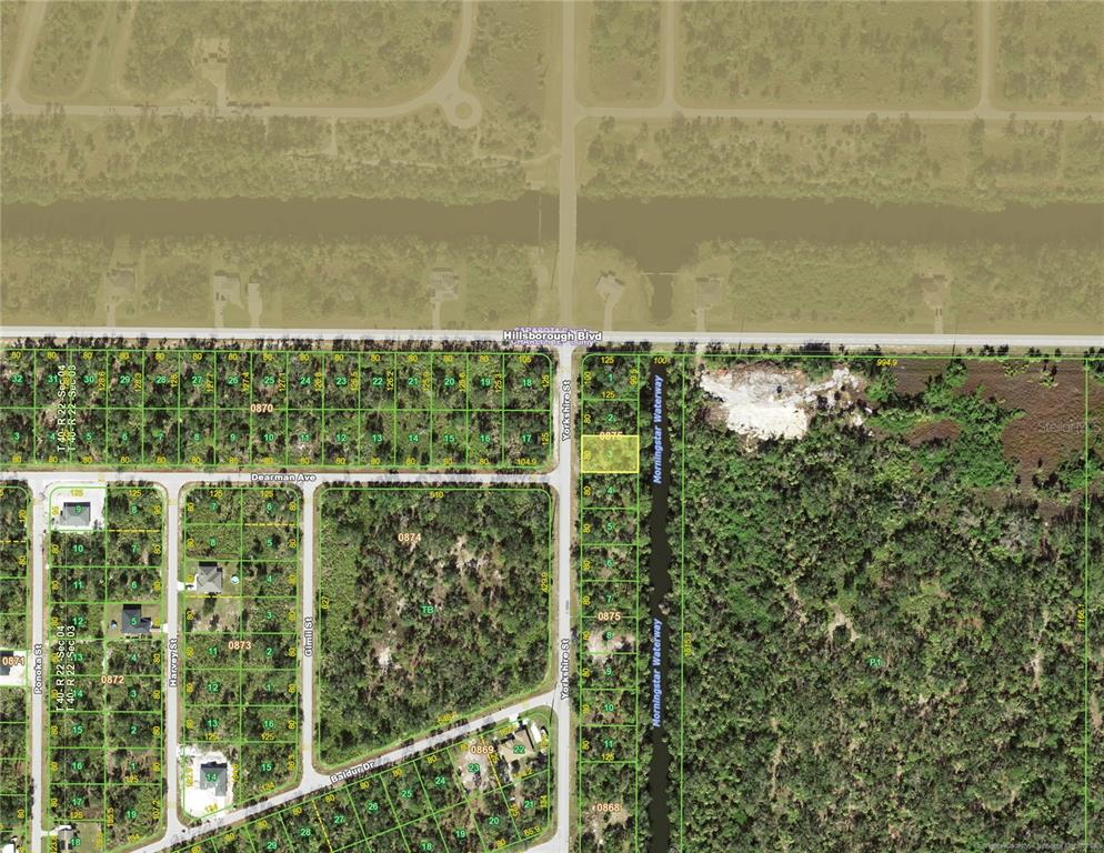 This is a satellite map showing residential land parcels, streets, and a waterway — 26 YORKSHIRE STREET, PORT CHARLOTTE, FL