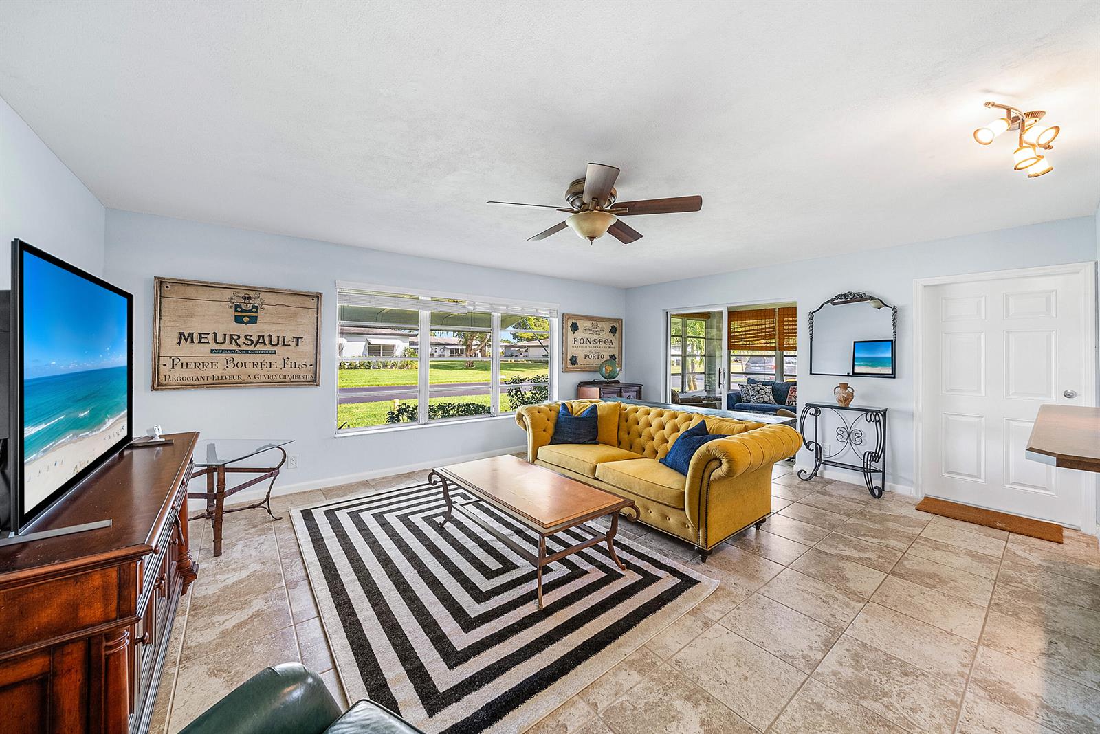 A kitchen with white cabinets, stainless steel appliances, a quartz countertop, and a window view — 510 High Point Drive # D, Delray Beach FL 33445, DELRAY BEACH, FL