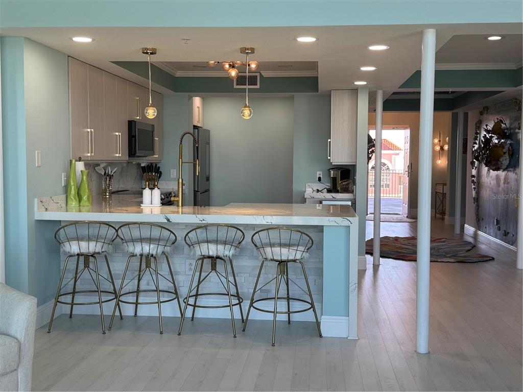 A hallway features underwater-themed murals, a sea-creature ceiling, and a colorful, textured area rug — 200 OCEAN CREST DRIVE UNIT 1112, PALM COAST, FL