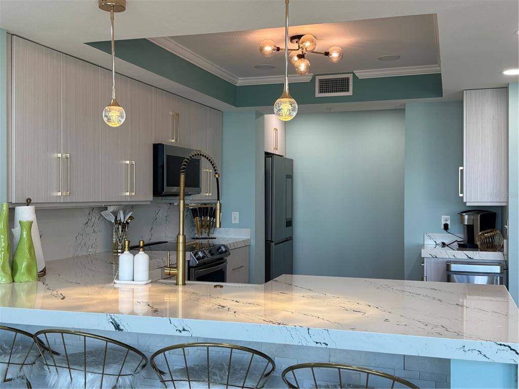 A living room features high ceilings, two large arched windows, and a view of the ocean — 200 OCEAN CREST DRIVE UNIT 1112, PALM COAST, FL
