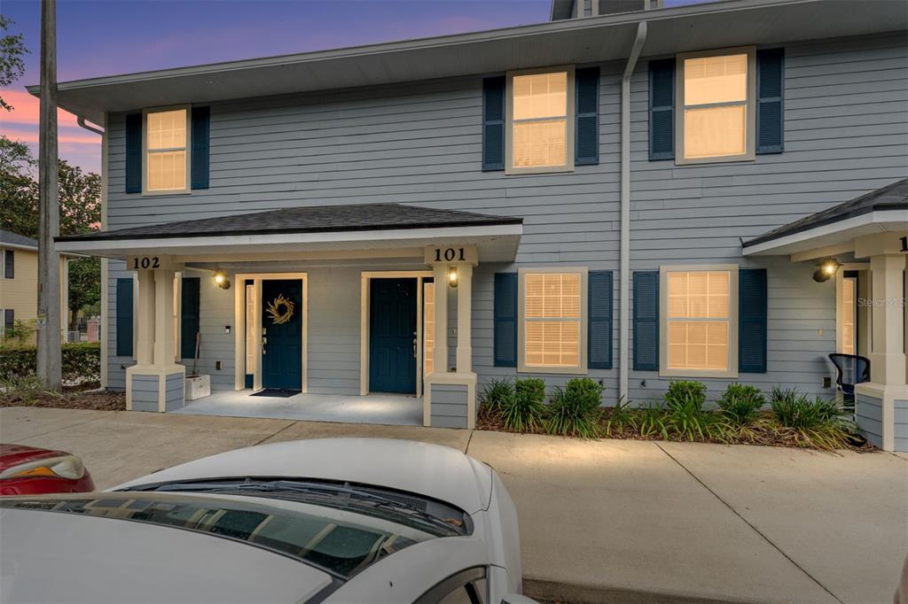 A two-story blue townhouse exterior with two front doors labeled 101 and 102 — 2980 SW 35TH PLACE UNIT 101, GAINESVILLE, FL