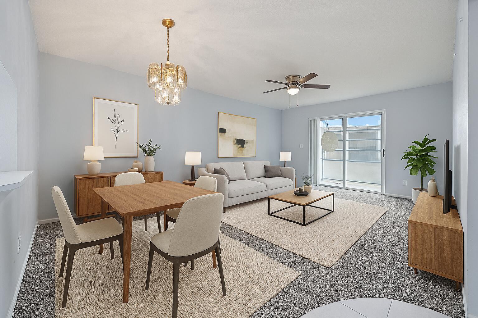 A living and dining room with light blue walls, neutral furniture, and a sliding glass door — 230 NE 26th Avenue # 206, Boynton Beach FL 33435, BOYNTON BEACH, FL