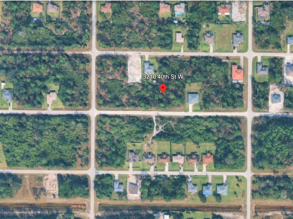 This is an aerial map view of a wooded residential lot in a suburban neighborhood — 3210 40TH STREET W, LEHIGH ACRES, FL