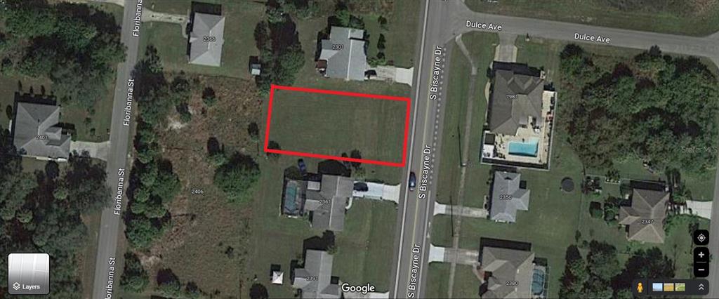 An aerial map view shows a vacant rectangular lot outlined in red between two streets — 2361 S BISCAYNE DRIVE, NORTH PORT, FL