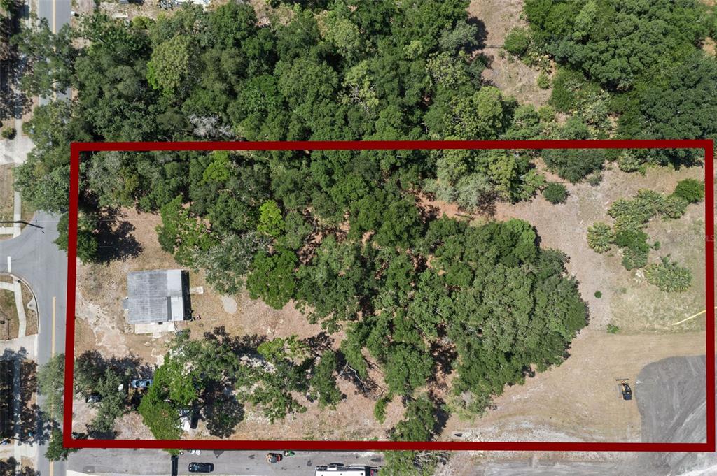 An aerial view shows a rectangular lot with a small house and dense tree coverage — 3932 WHITE HERON DRIVE, ORLANDO, FL