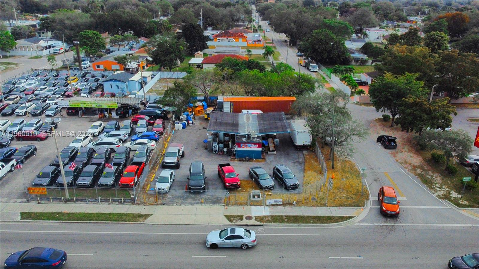 An aerial view shows a car dealership lot with numerous vehicles parked on the property — 9301 NW 27th Ave, Miami FL 33147, MIAMI, FL