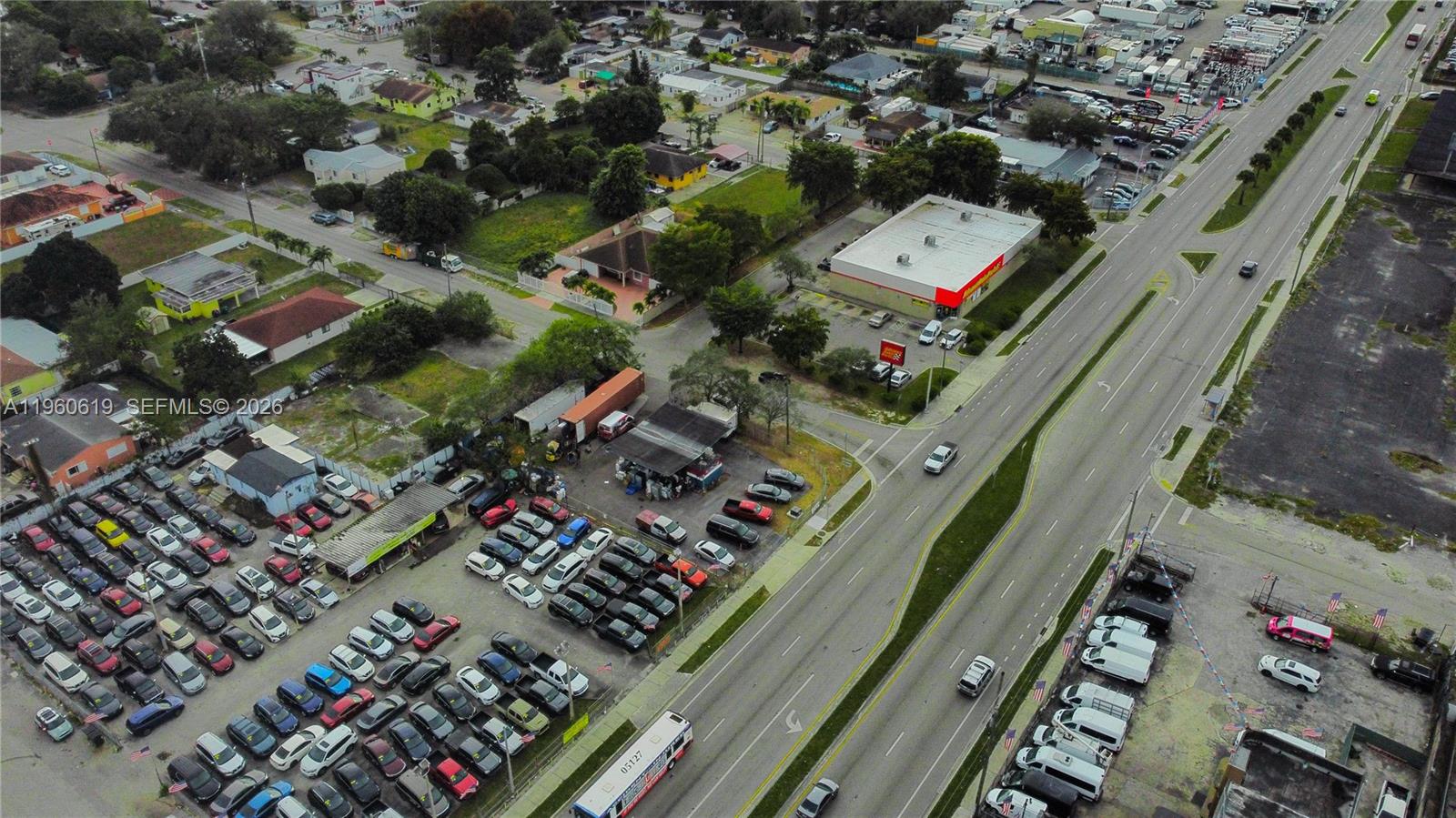 An aerial view shows a car dealership lot adjacent to a multi-lane road — 9301 NW 27th Ave, Miami FL 33147, MIAMI, FL