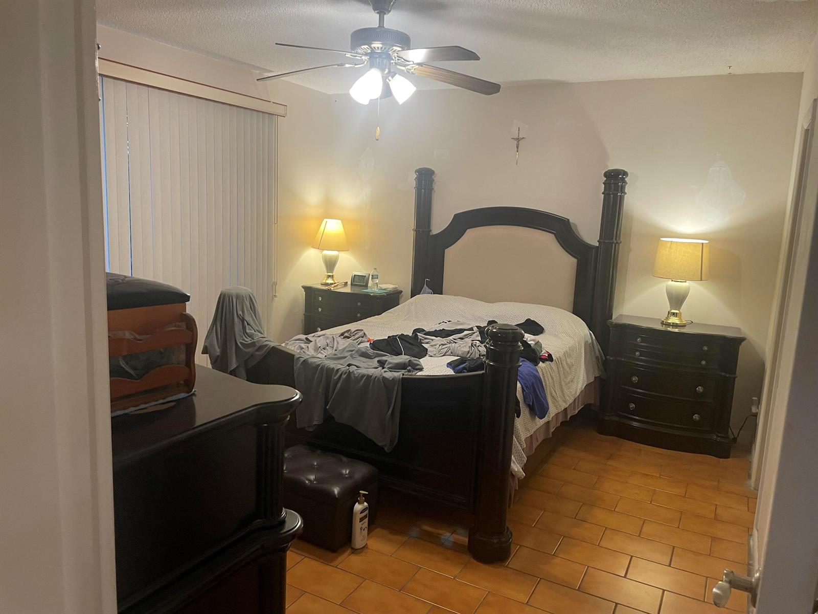 A bedroom features a dark wood poster bed, two matching nightstands, and tile flooring — 1101 NW 58th Terrace # 404, Sunrise FL 33313, SUNRISE, FL