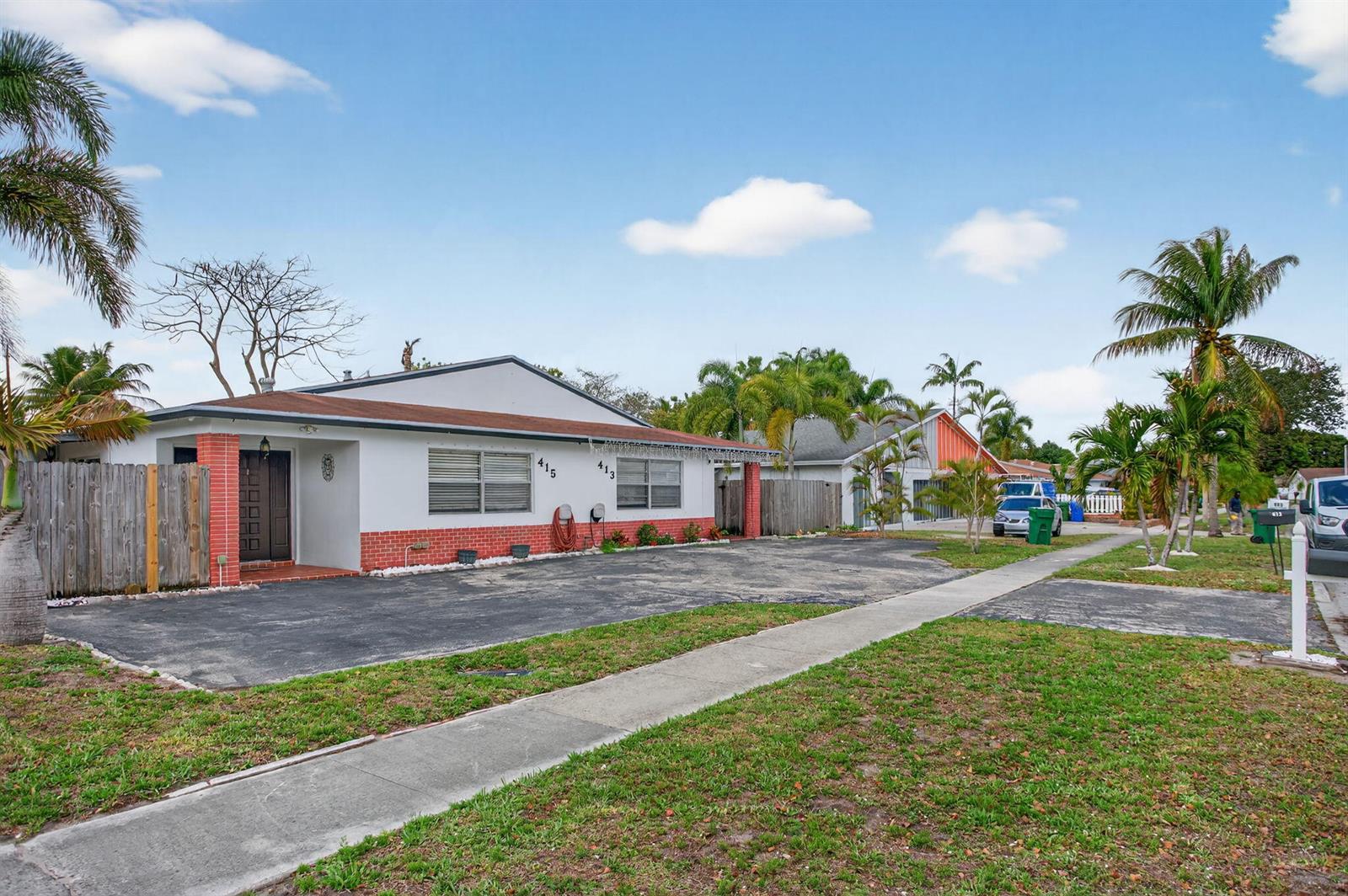 A single-story house with a white facade, red brick base, and a paved driveway — 415 SW 61st Terrace, Margate FL 33068, MARGATE, FL