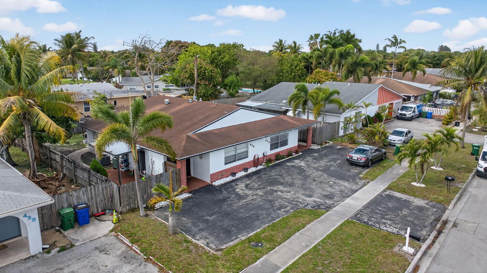 An aerial view shows a single-story house with a large asphalt driveway and palm trees — 415 SW 61st Terrace, Margate FL 33068, MARGATE, FL