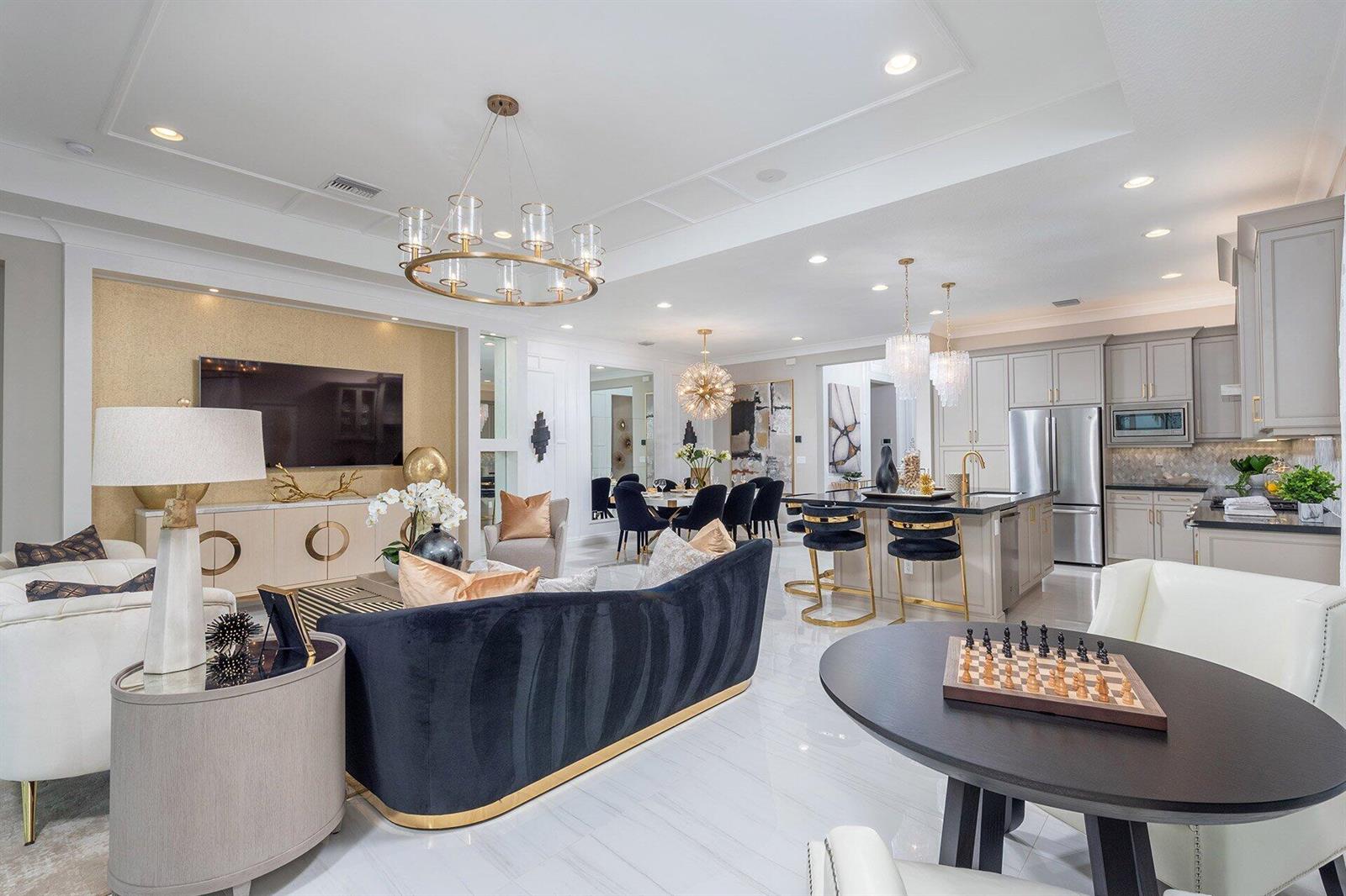 A bright living room features a white sectional sofa, a round coffee table, and sliding doors — 11311 Virginia Pine Court, Boynton Beach FL 33473, BOYNTON BEACH, FL