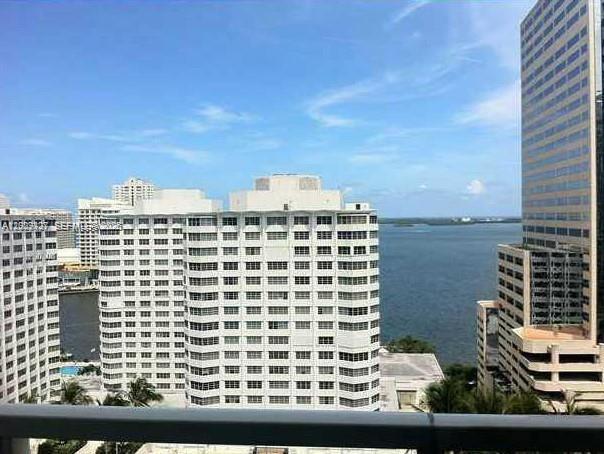 A high-angle view of white apartment buildings overlooking a bay under a blue sky — 951 Brickell Ave # 1808, Miami FL 33131, MIAMI, FL