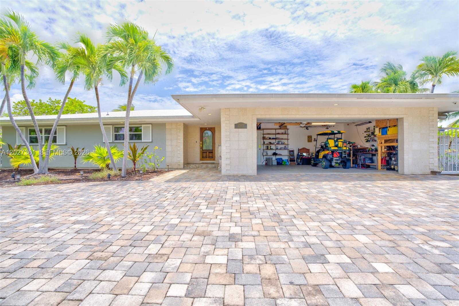 A single-story house features a paved driveway, a two-car carport, and several palm trees — 2919 Sombrero Blvd, Key Largo FL 33050, KEY LARGO, FL