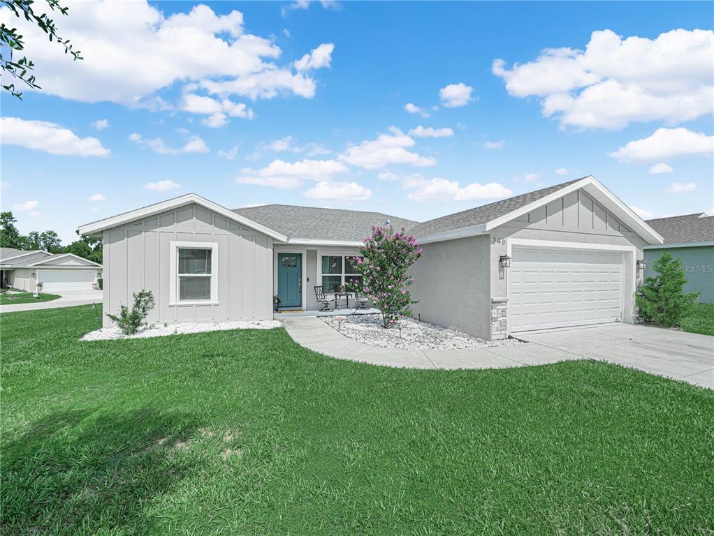 A single-story house with light gray siding, a two-car garage, and a front lawn — 346 HIDDEN CREEK, WAUCHULA, FL