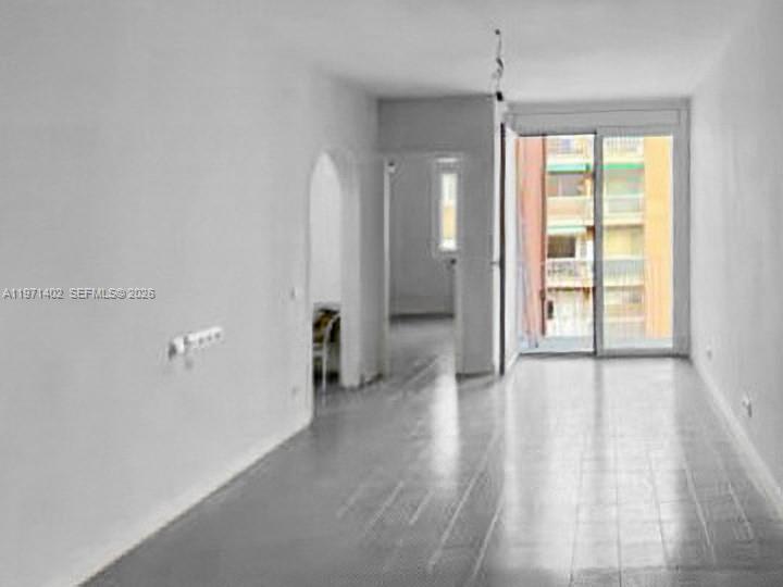An empty room with white walls, light-colored flooring, and a sliding glass door to a balcony — Sant Antoni Maria Claret # 77, NJ 08025, NJ
