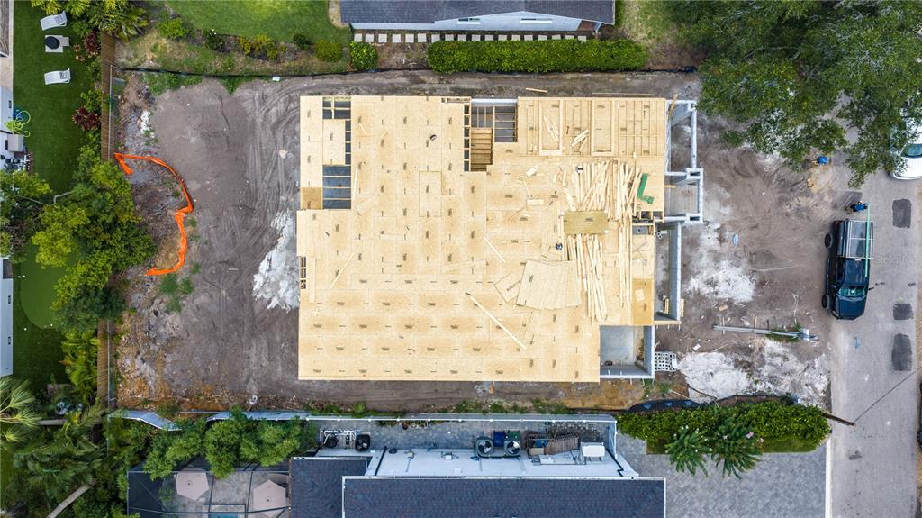 An aerial view shows a residential construction site with a wooden subfloor installed — 4506 W MELROSE AVENUE, TAMPA, FL
