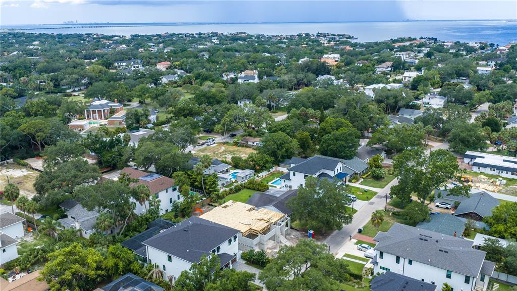 An aerial view shows a residential neighborhood with a house under construction in the center — 4506 W MELROSE AVENUE, TAMPA, FL