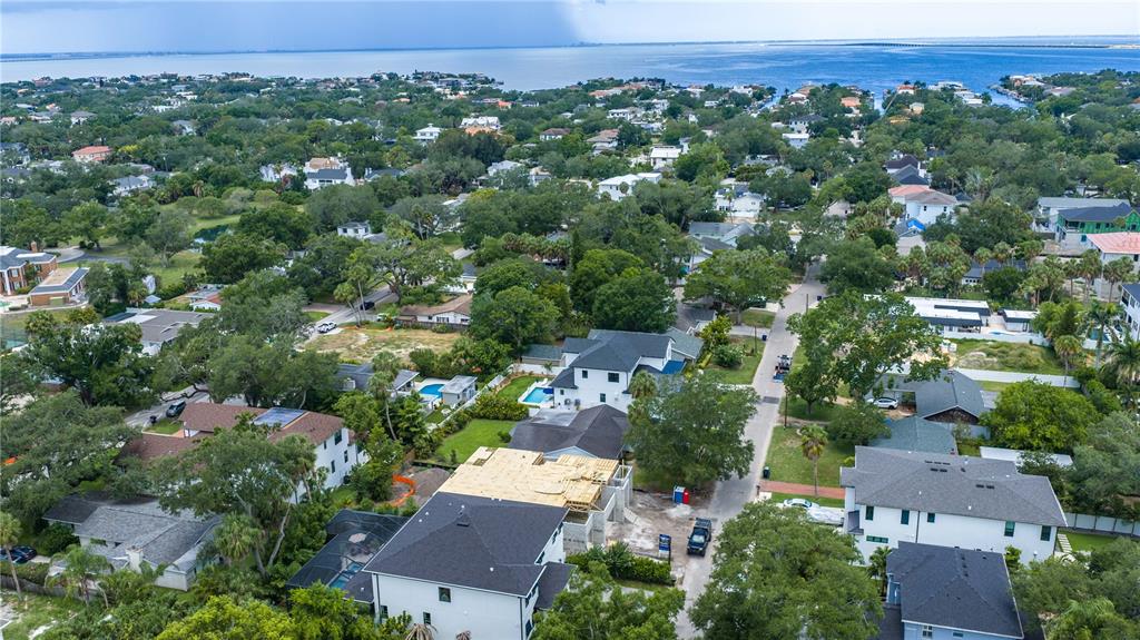 An aerial view shows a residential neighborhood with several houses, including one under construction — 4506 W MELROSE AVENUE, TAMPA, FL