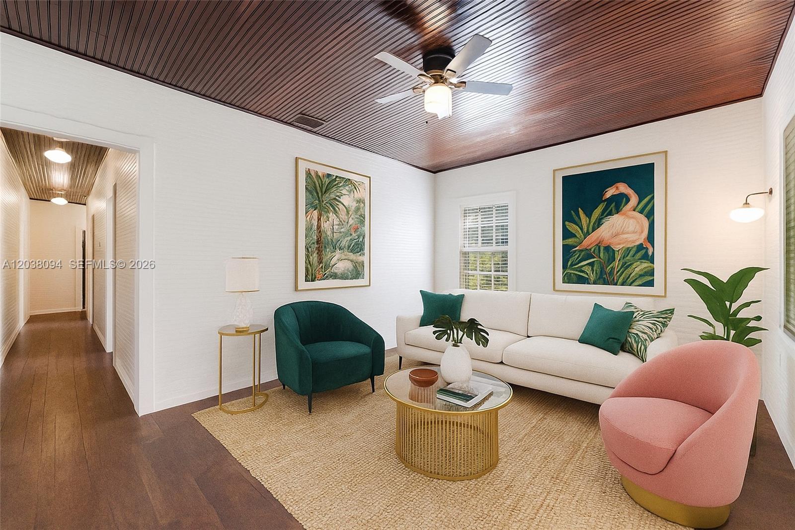 A living room features a wood-paneled ceiling, white walls, and a mix of colorful furniture — 3826 Oak Ave # 3826, Miami FL 33133, MIAMI, FL