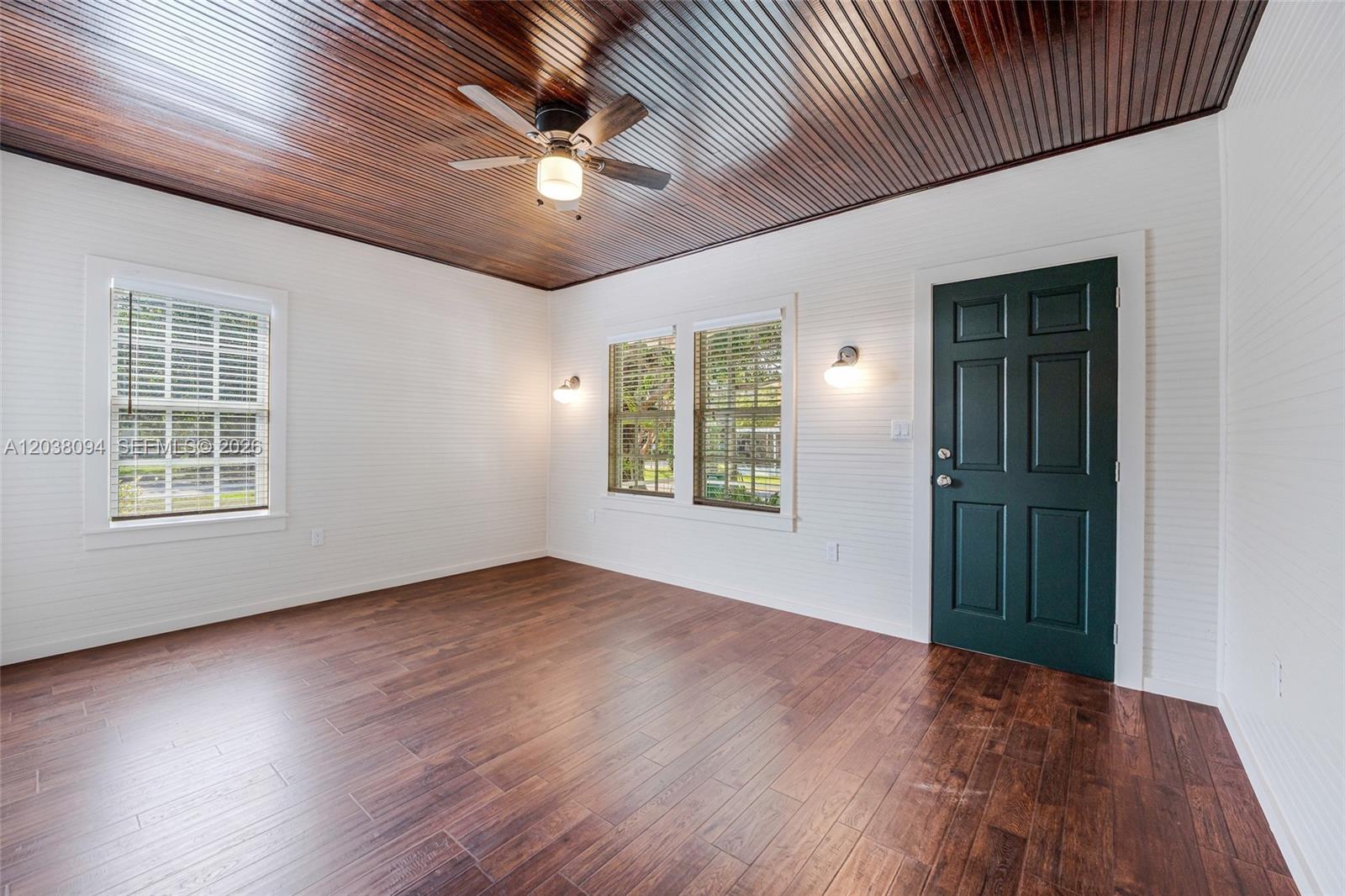 A room with white beadboard walls, a dark wood-paneled ceiling, and dark wood-look flooring — 3826 Oak Ave # 3826, Miami FL 33133, MIAMI, FL