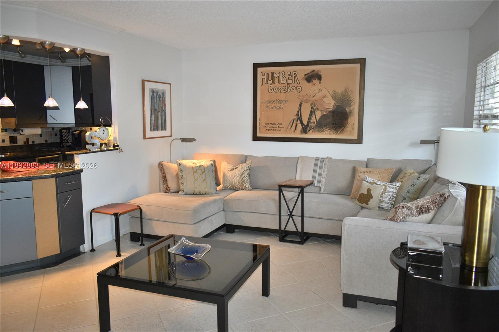 A living room features a beige sectional sofa, a glass coffee table, and framed wall art — 2011 Cornwall # A, Boca Raton FL 33434, BOCA RATON, FL