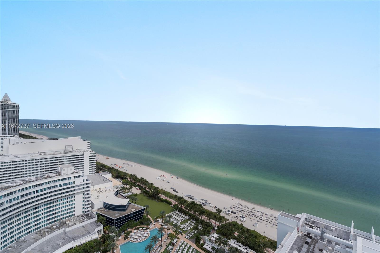 An elevated view shows a sandy beach, turquoise ocean, and surrounding high-rise buildings — 4401 Collins Ave, Miami Beach FL 33140, MIAMI BEACH, FL