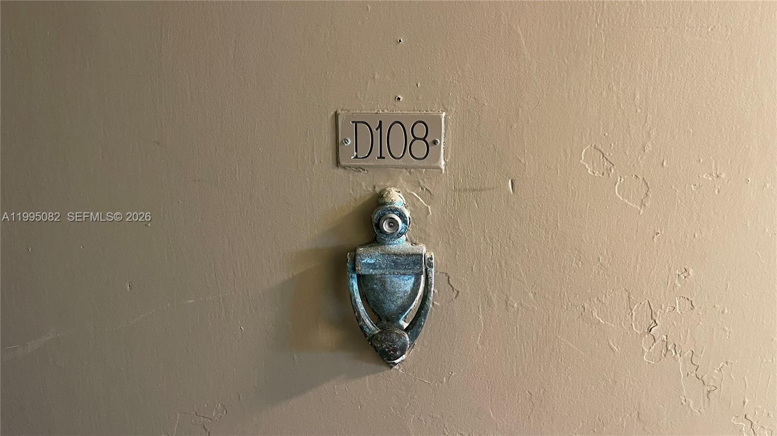 A door features a metal room number sign labeled D108 and a brass door knocker — 10801 SW 109th Ct # D108, Miami FL 33176, MIAMI, FL