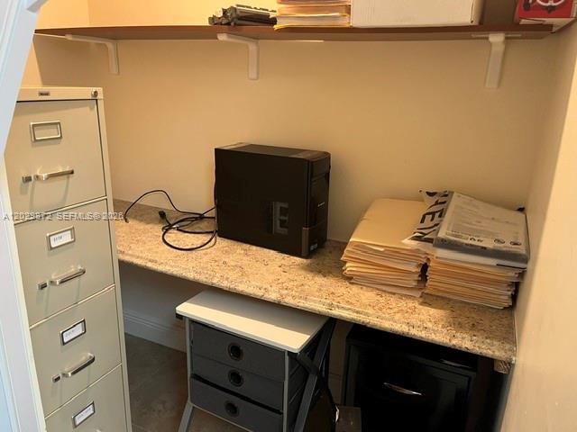 A small office closet features a granite countertop, a computer tower, and a filing cabinet — 8260 W Flagler St, Miami FL 33144, MIAMI, FL