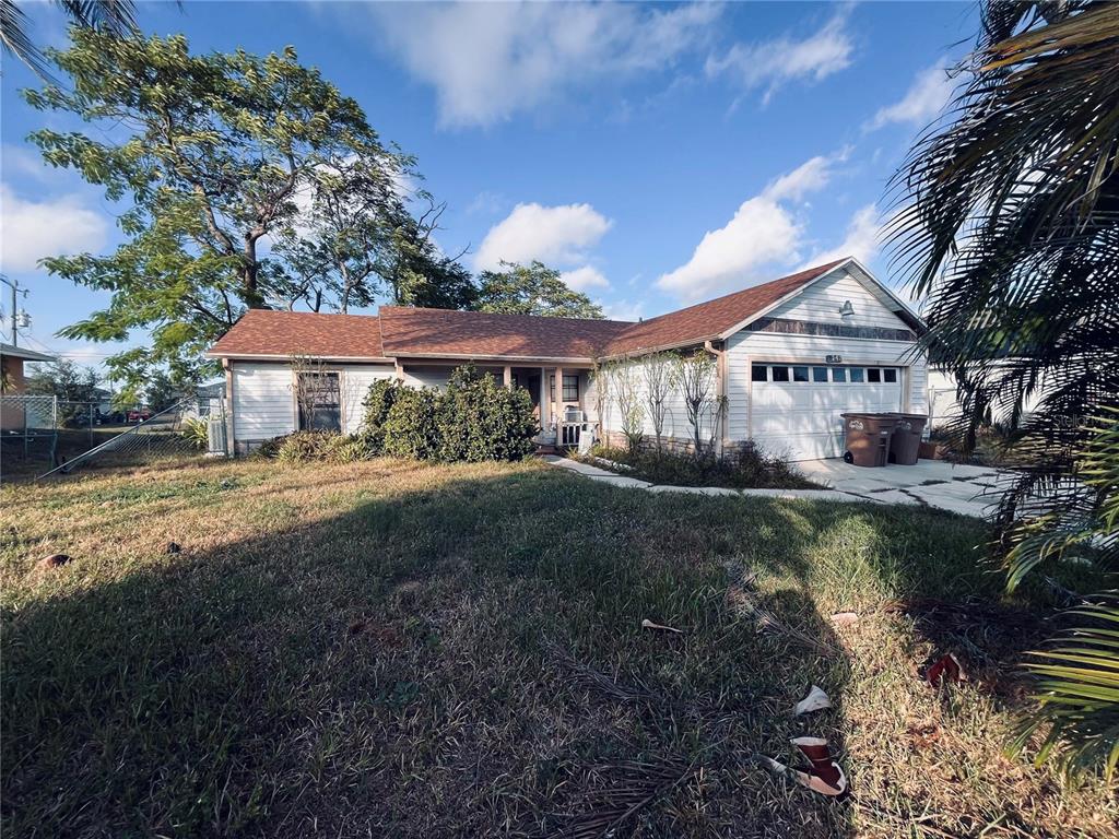 A single-story house with white siding, a brown roof, and a two-car garage — 2247 SW 4TH STREET, CAPE CORAL, FL
