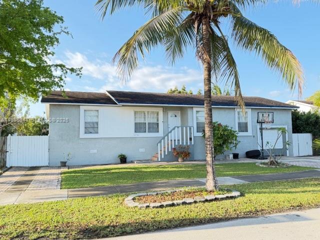 A single-story house with a palm tree in the front yard and a basketball hoop — 9770 SW 210th St, Cutler Bay FL 33189, CUTLER BAY, FL