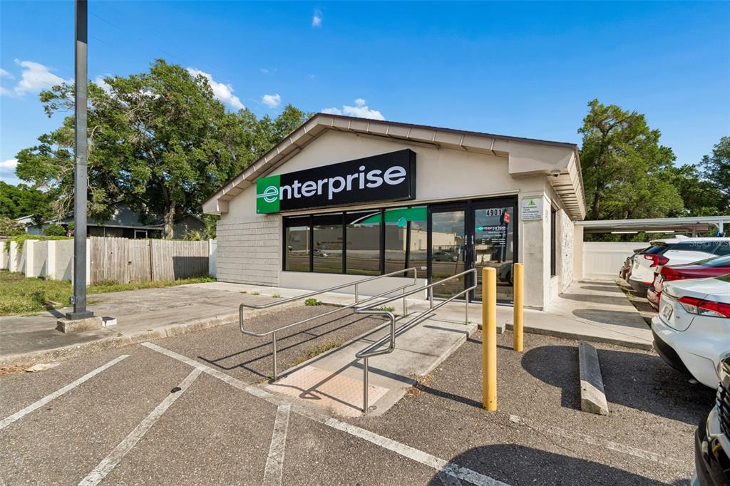 An exterior view of an Enterprise Rent-A-Car office building with a wheelchair ramp — 4901 E BUSCH BOULEVARD, TAMPA, FL