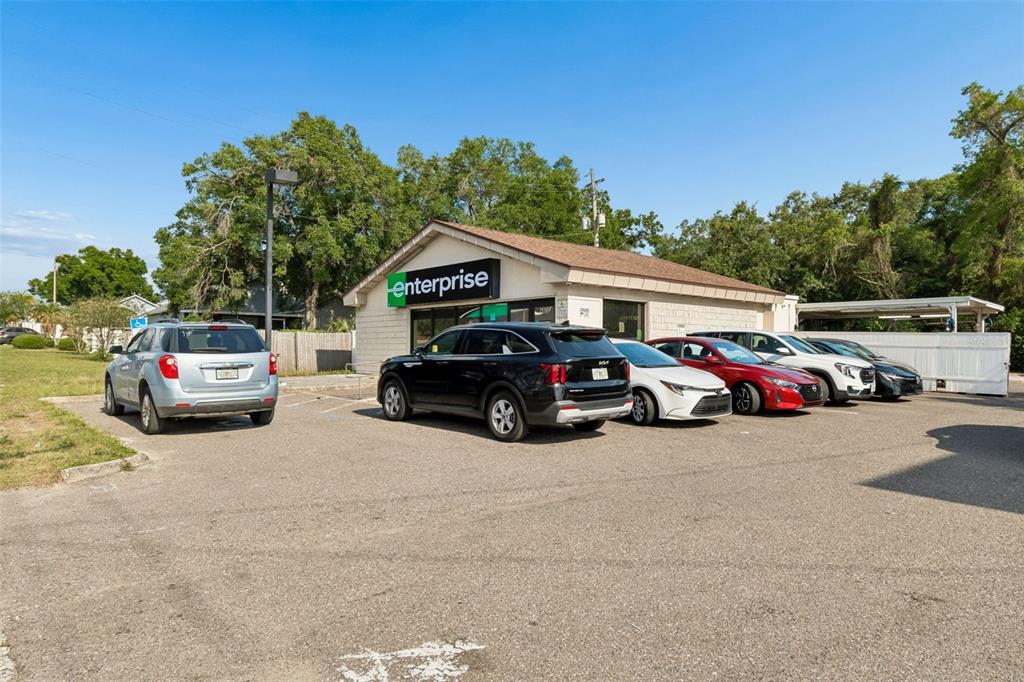 An Enterprise Rent-A-Car office building with a parking lot containing several rental vehicles — 4901 E BUSCH BOULEVARD, TAMPA, FL