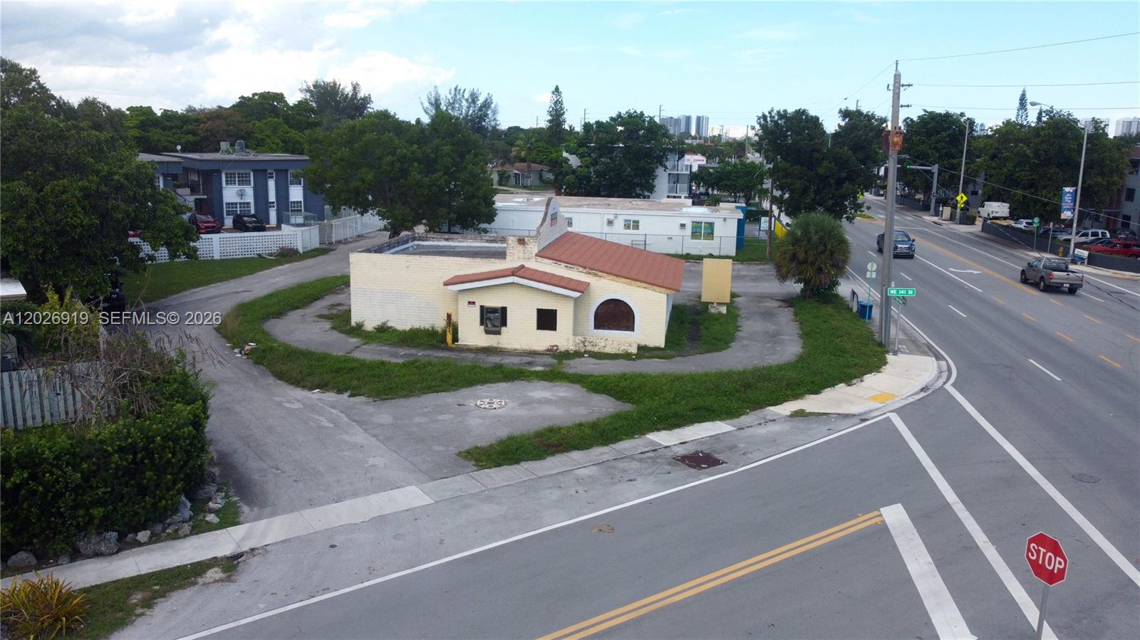 An aerial view shows a small, single-story building with a red roof on a corner lot — 14100 W Dixie Hwy, North Miami FL 33161, NORTH MIAMI, FL