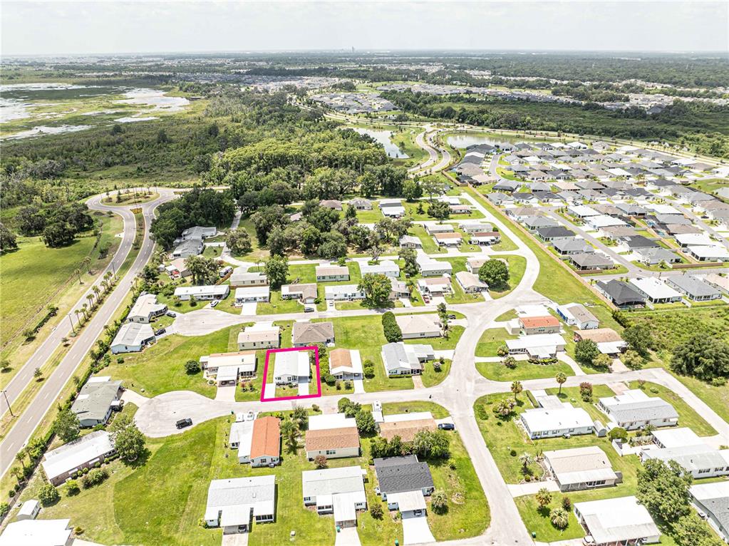 An aerial view shows a residential neighborhood with a single house highlighted by a pink border — 5217 CAMBRIDGE COURT, WILDWOOD, FL
