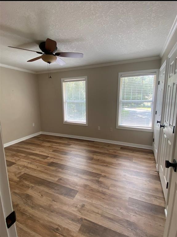 A kitchen features white cabinets, stainless steel appliances, a white stove, and a central island — 4574 SW 48TH WAY UNIT 103, GAINESVILLE, FL