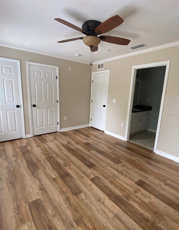 A kitchen features a central island with a white countertop, tile flooring, and a window — 4574 SW 48TH WAY UNIT 103, GAINESVILLE, FL
