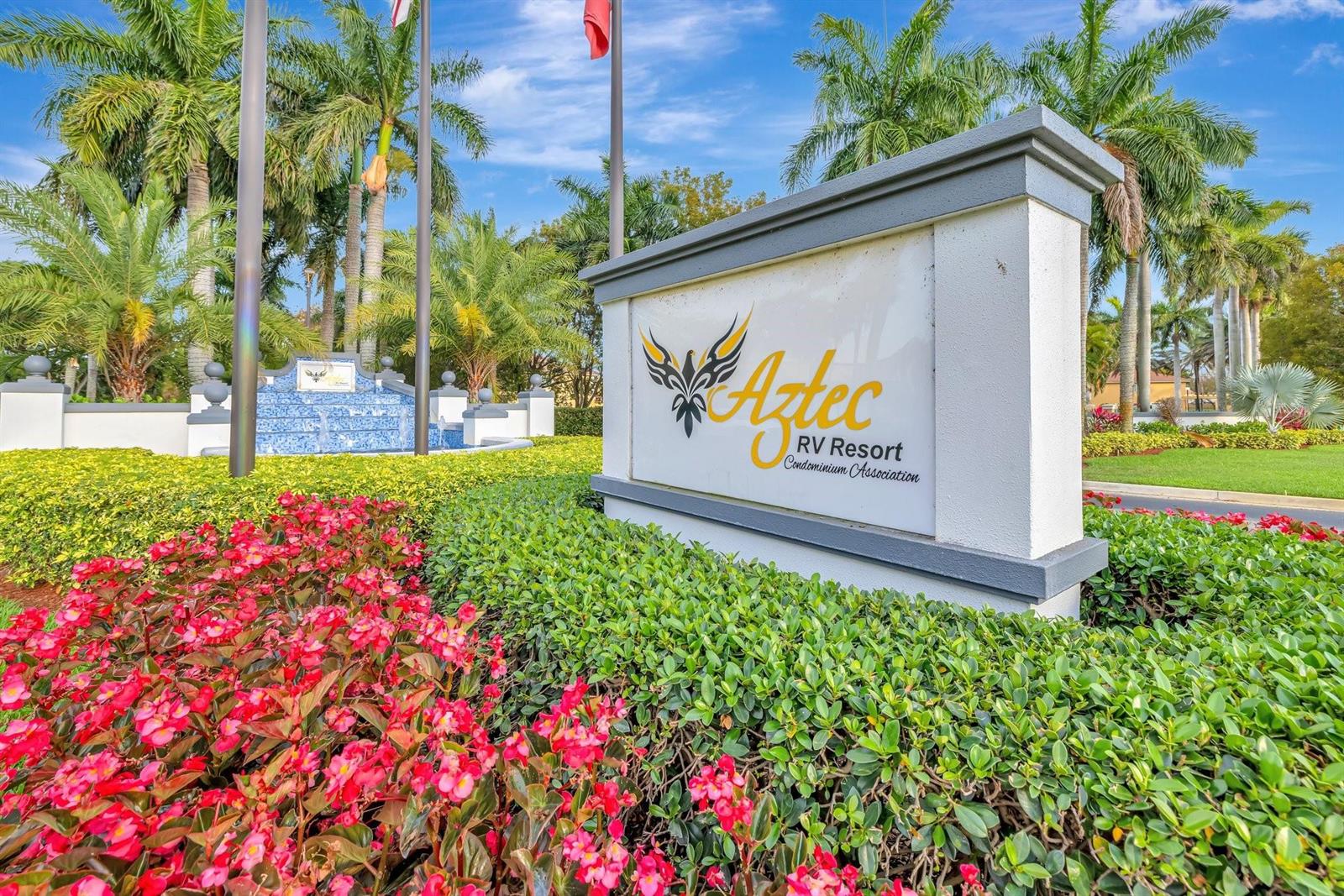 A sign for the Aztec RV Resort Condominium Association stands in front of landscaped gardens — 78 S Cortez Drive # 78, Pompano Beach FL 33068, POMPANO BEACH, FL