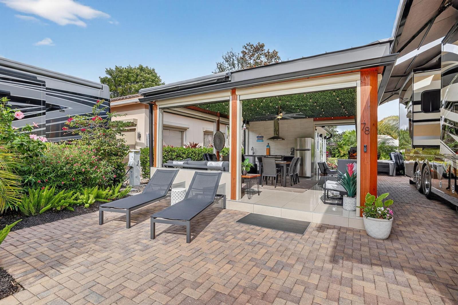 An outdoor patio features a covered dining area, lounge seating, and two poolside lounge chairs — 78 S Cortez Drive # 78, Pompano Beach FL 33068, POMPANO BEACH, FL