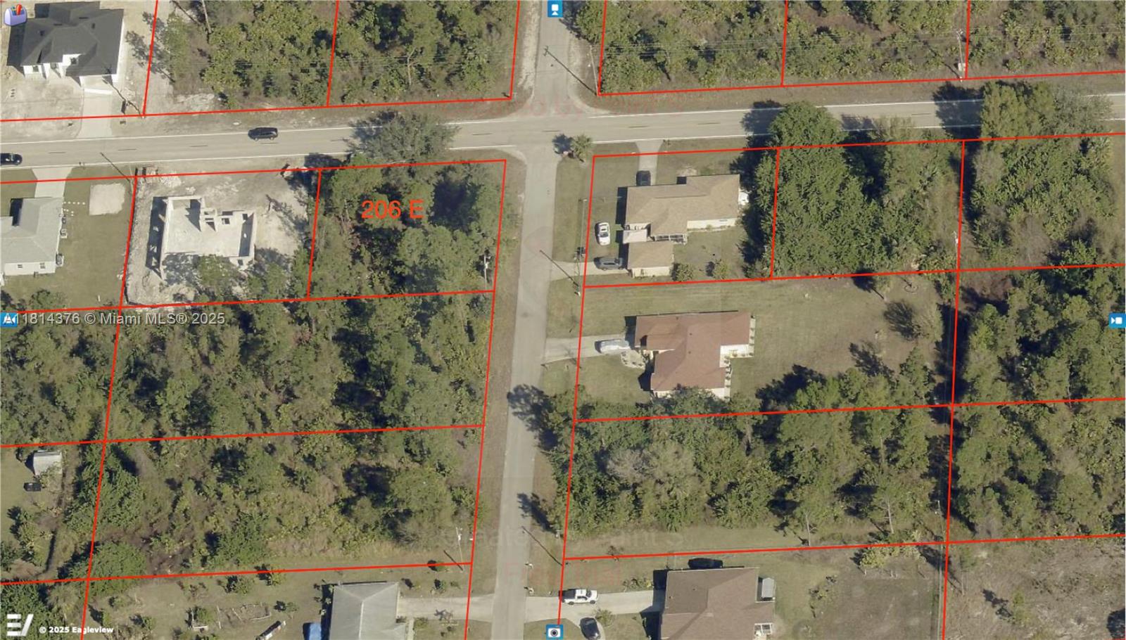 This aerial map shows several residential lots, some with houses and others with wooded vegetation — 206 E 10 ST, Lehigh Acres FL 33972, LEHIGH ACRES, FL