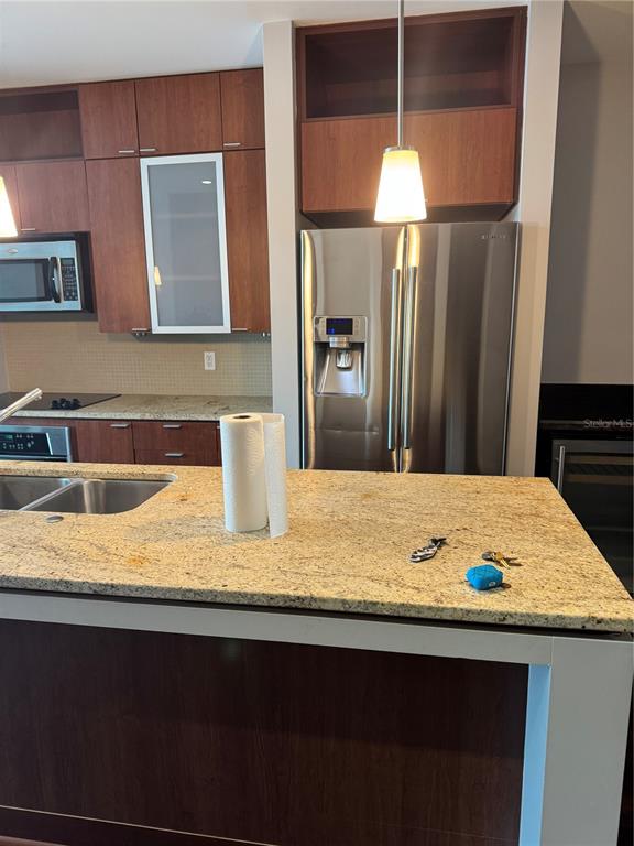 A kitchen features wood cabinets, stainless steel appliances, and a granite-topped island — 912 CHANNELSIDE DRIVE UNIT 2803, TAMPA, FL