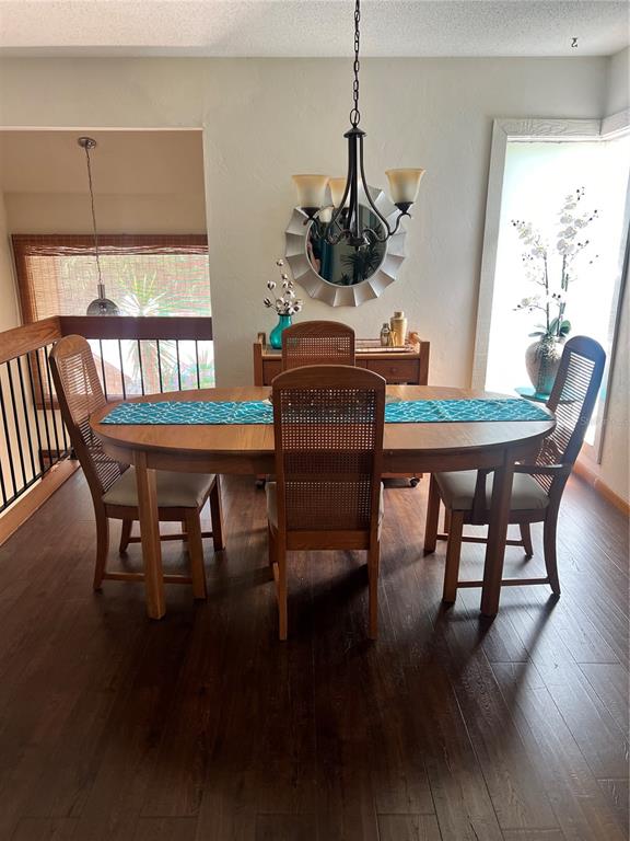 A dining room features a wooden table, four cane-back chairs, and a chandelier — 10 OAKMONT COURT UNIT 10, PALM COAST, FL