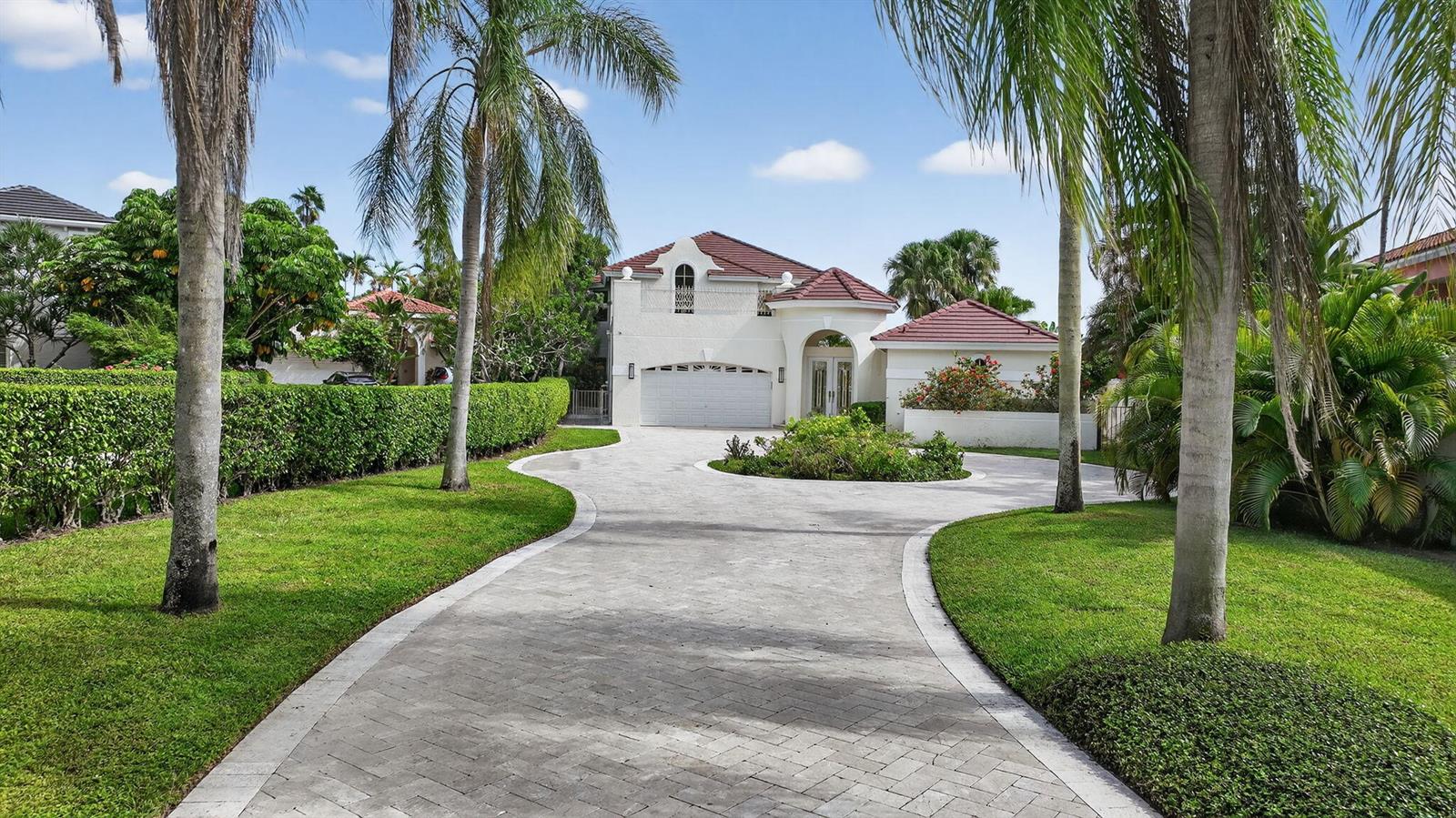 A two-story house with a tiled roof and a circular paved driveway sits behind landscaping — 16670 Senterra Drive, Delray Beach FL 33484, DELRAY BEACH, FL