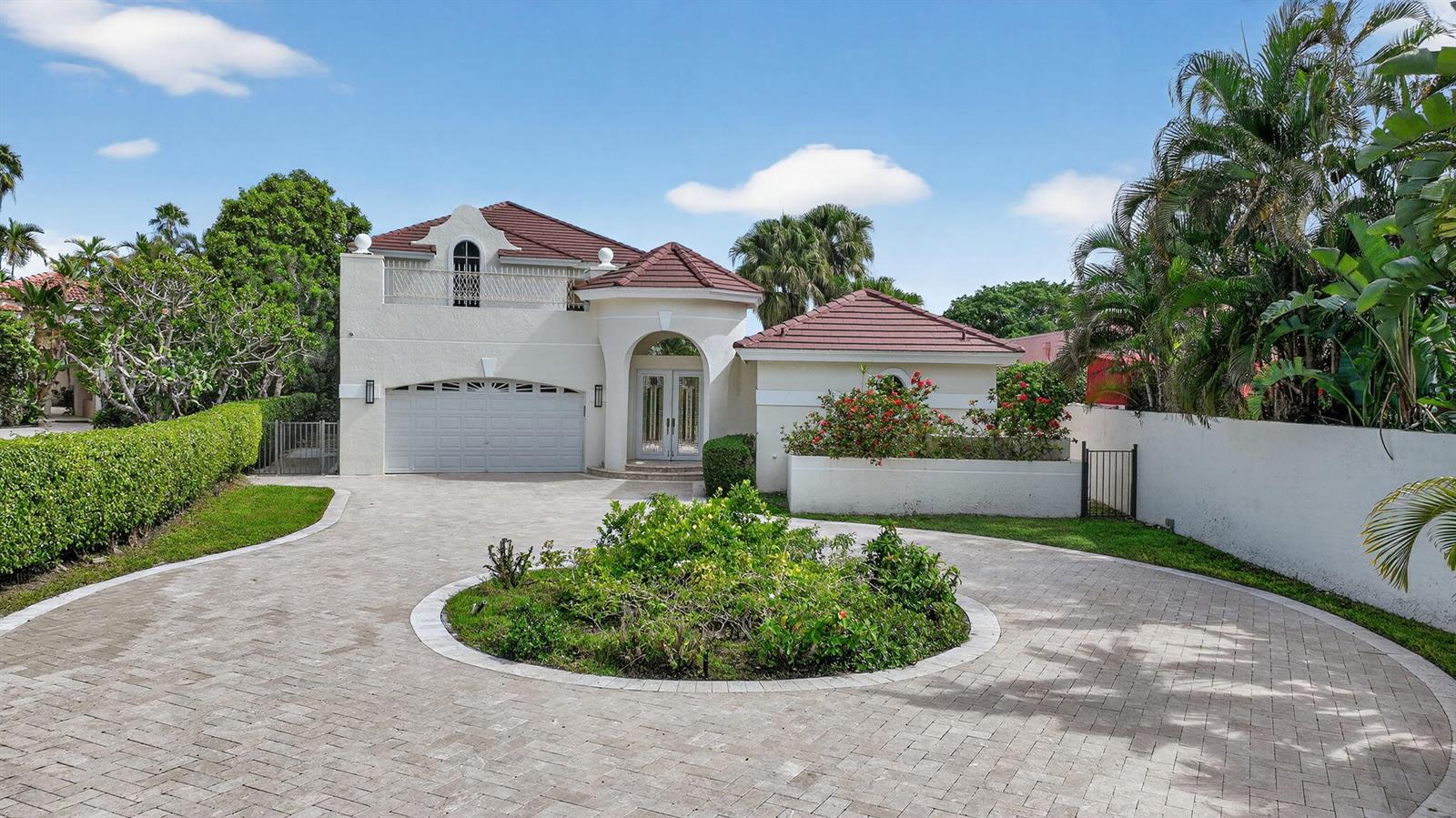 A two-story house with a circular paver driveway, a garage, and a balcony — 16670 Senterra Drive, Delray Beach FL 33484, DELRAY BEACH, FL